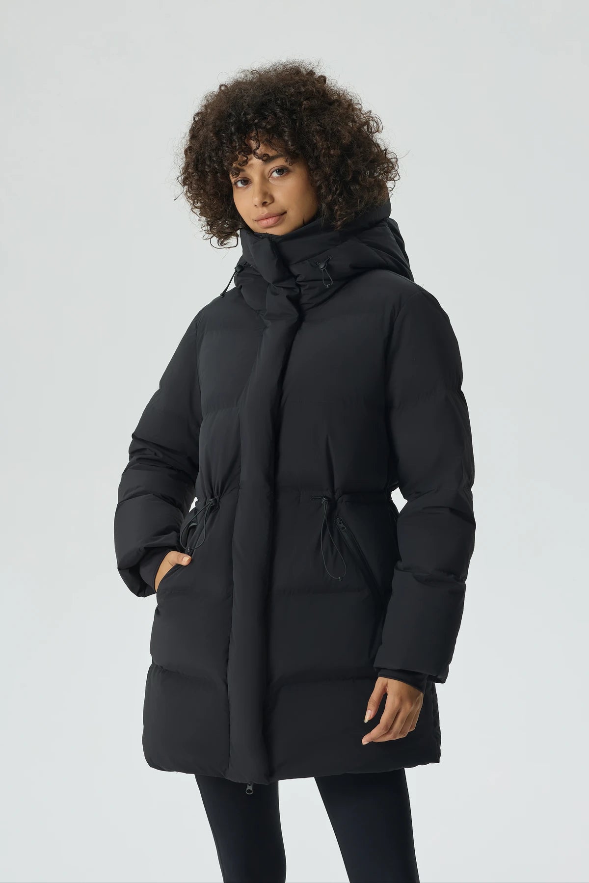 A woman wearing a black Nimbus short down puffer.